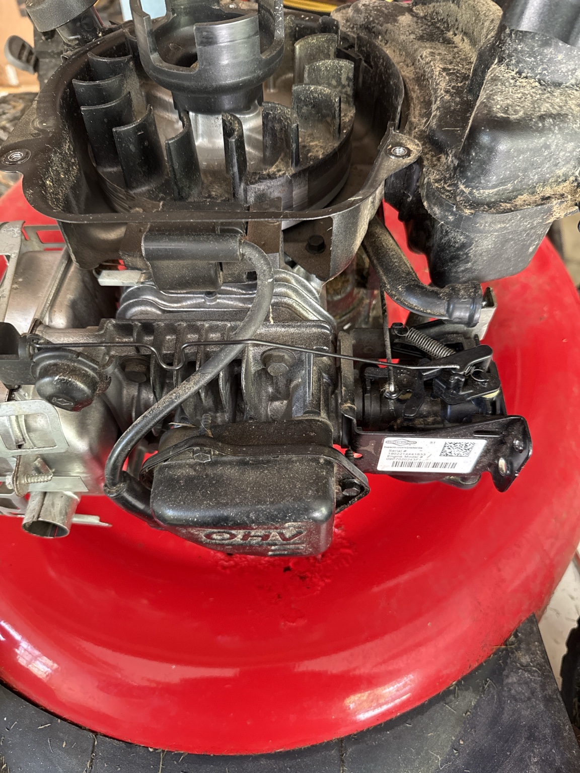Governor linkage and spring assembly on the lawnmower carburetor