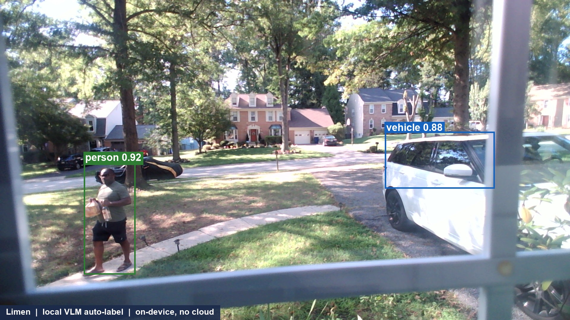 A front-window view: me walking up the path to the door holding a bag and a bottle, tagged on device with a green person box, my vehicle boxed with a blue vehicle label, captioned Limen local VLM auto-label on-device no cloud